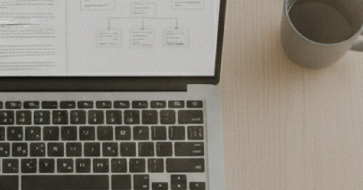 Laptop on a conference table recording a meeting while AI-organized notes appear on screen
